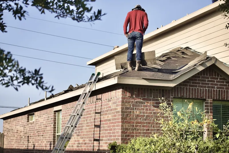 Professional roofer working on a residential roof in Homeland Park